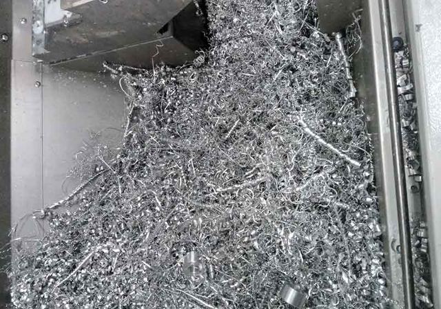Loose curled aluminium turnings collected in a container