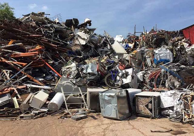 Mixed light-gauge metal scrap and compact bales in a recycling yard